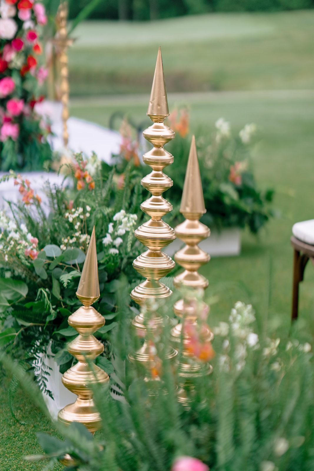 Tall gold kalash decor in a garden