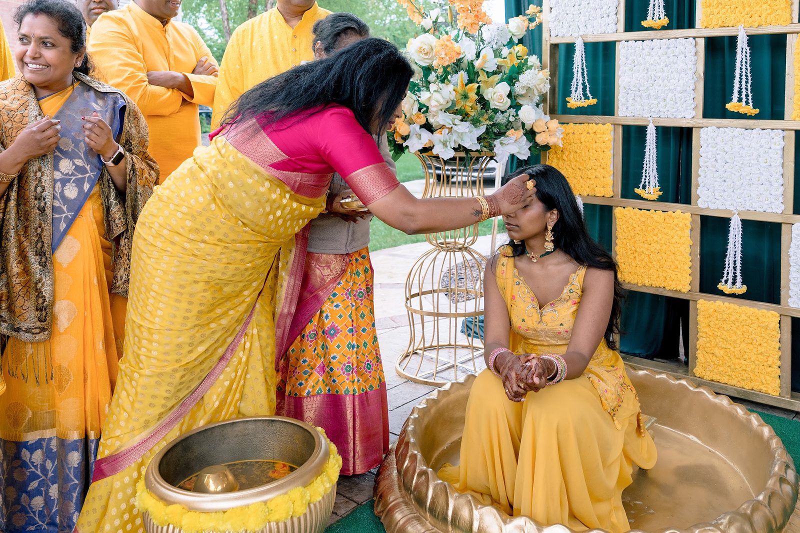 Family applying haldi to the bride