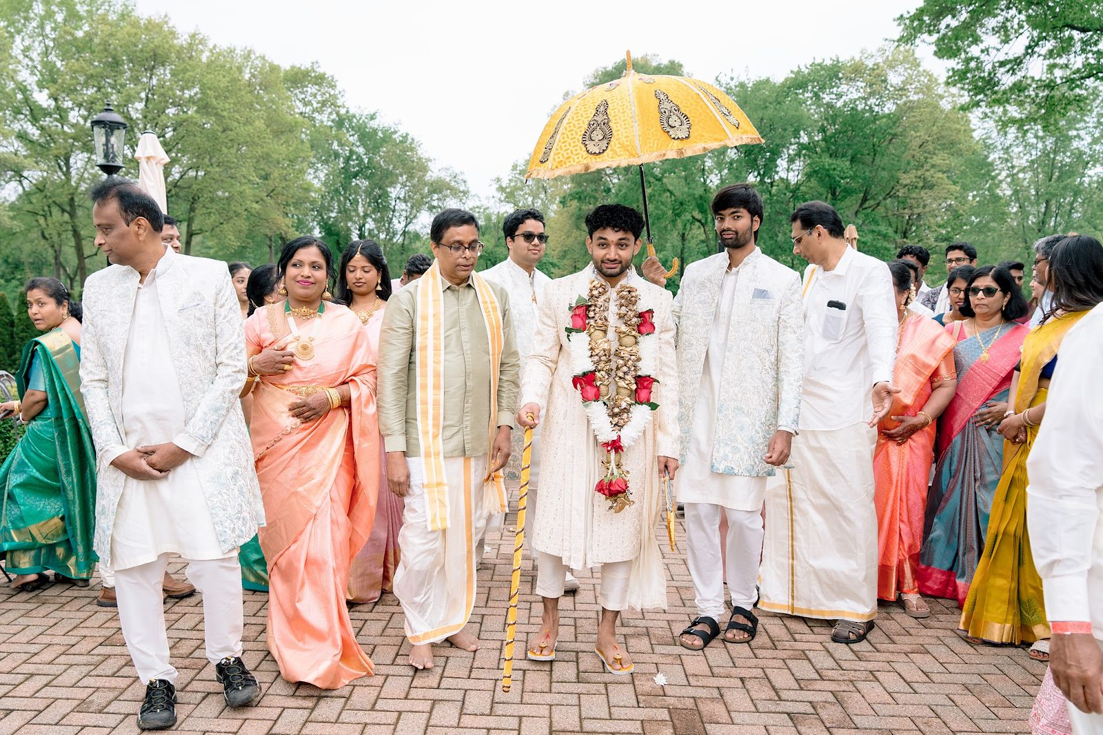Groom under a yellow umbrella during the Kashi Yatra