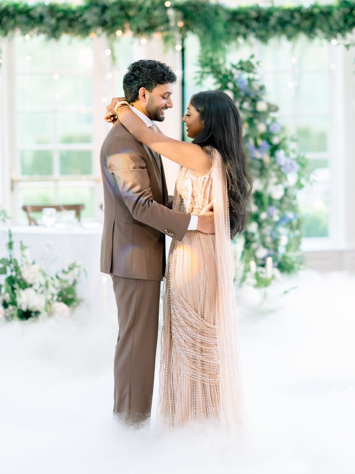 Couple sharing a first dance over a floor of fog