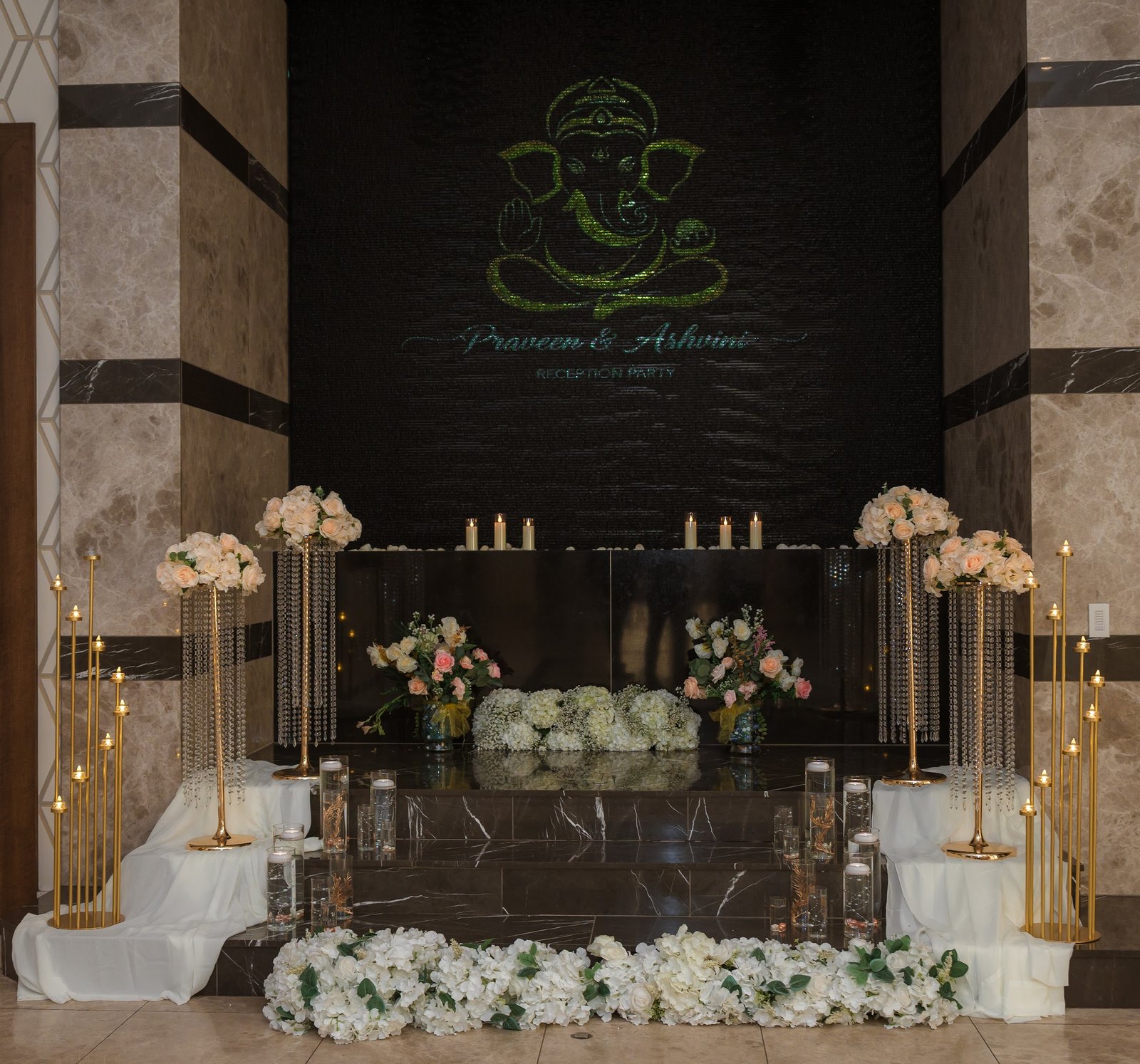 Ganesha monogram wall with white florals and candles